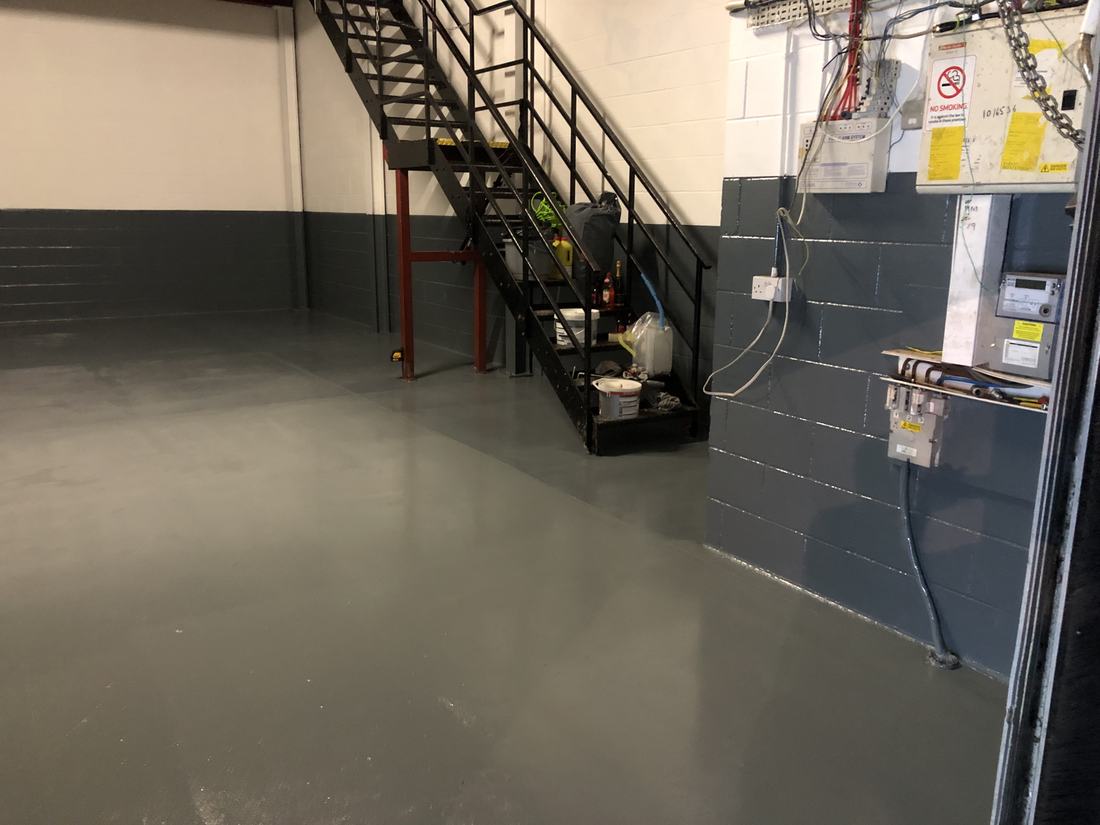 A newly coated grey floor in a commercial building