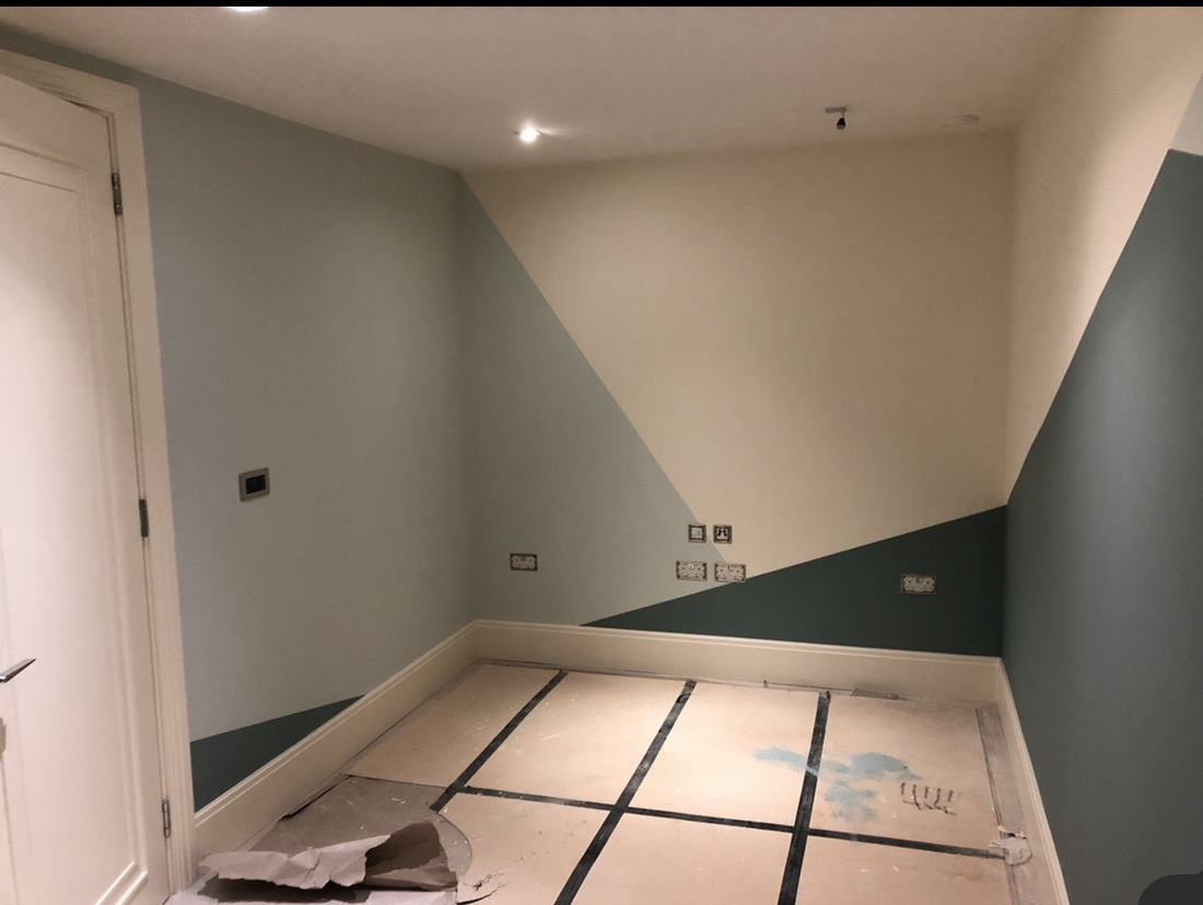 A freshly painted room with a two-tone geometric wall