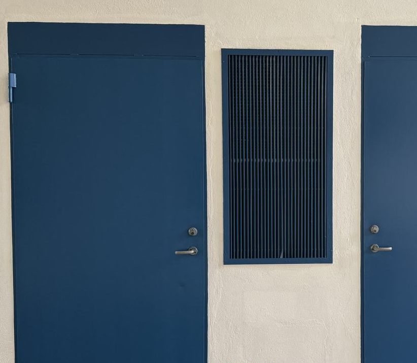 Steel doors and a vent painted deep blue