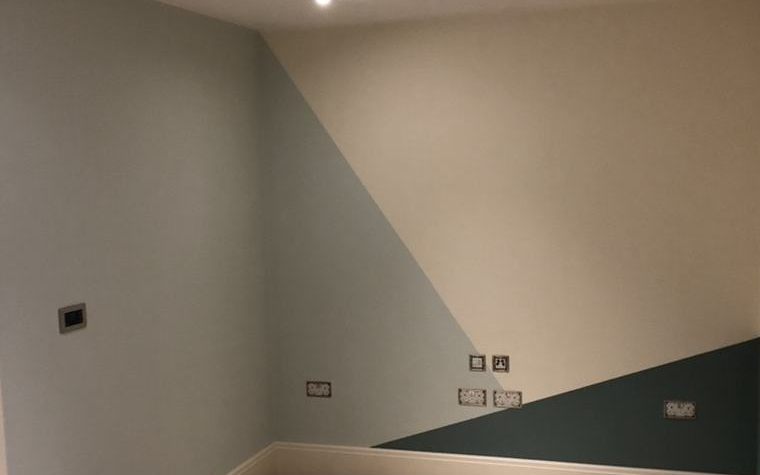 A freshly painted room with a two-tone geometric wall