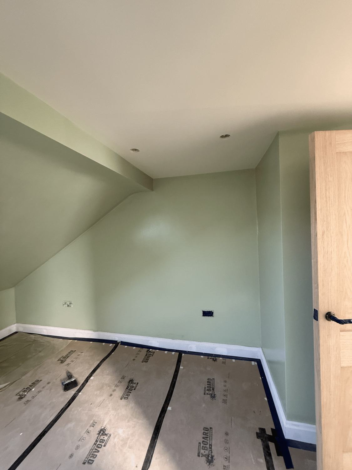 A room painted soft sage green