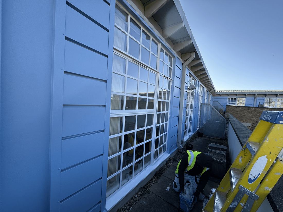 Blue painted window frames on an industrial building